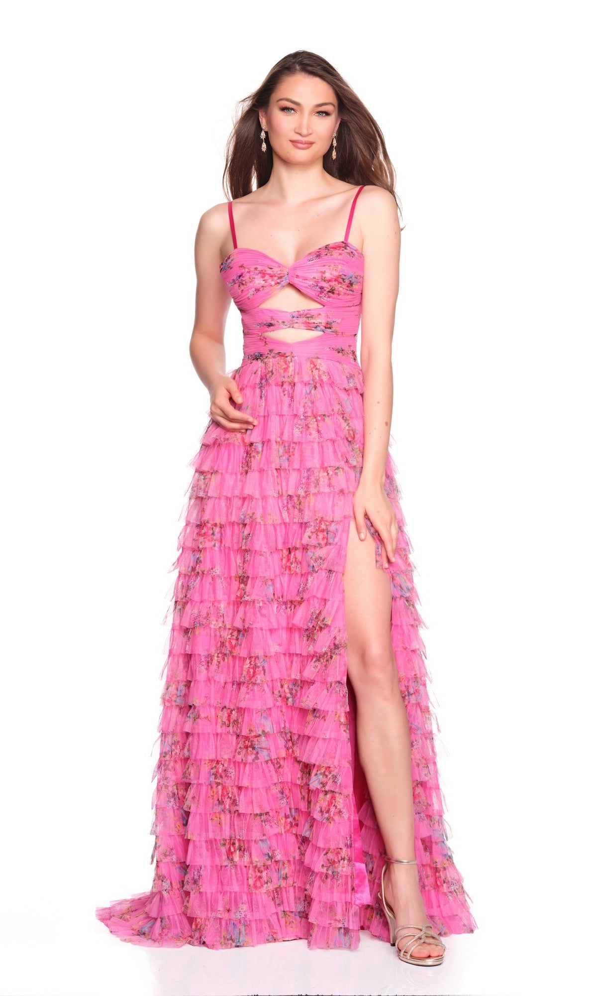 Woman wearing the Dave and Johnny 12685 long prom dress in fuchsia pink, with an A-line ruffled tulle skirt, floral accents, high slit, and waist cut-out, posing against a white background.
